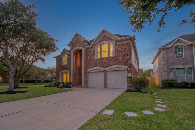 view of front of home featuring a lawn and a garage