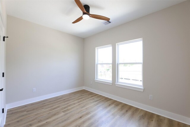 empty room featuring light wood-type flooring and ceiling fan