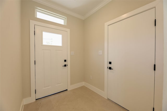 foyer entrance with light floors, baseboards, and crown molding