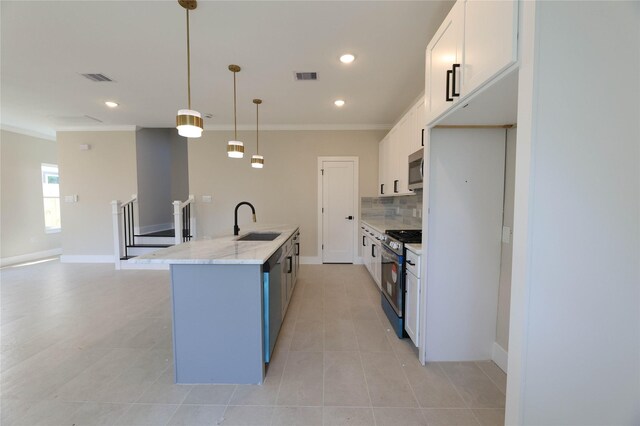 kitchen featuring sink, white cabinets, appliances with stainless steel finishes, decorative light fixtures, and light stone countertops