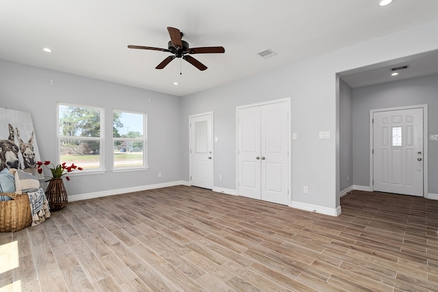 interior space with light wood-type flooring and ceiling fan