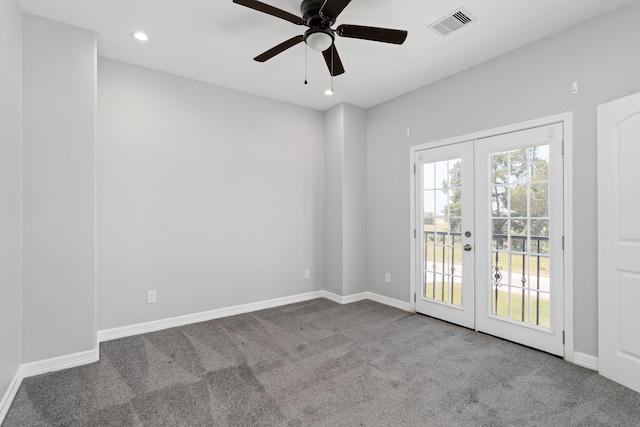 carpeted spare room with french doors and ceiling fan