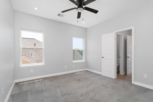 unfurnished bedroom with ceiling fan and light carpet