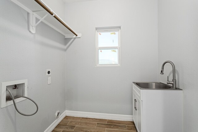 clothes washing area with washer hookup, dark hardwood / wood-style flooring, electric dryer hookup, and sink