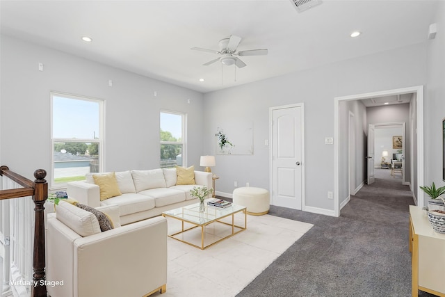 living room with light carpet, ceiling fan, and a healthy amount of sunlight