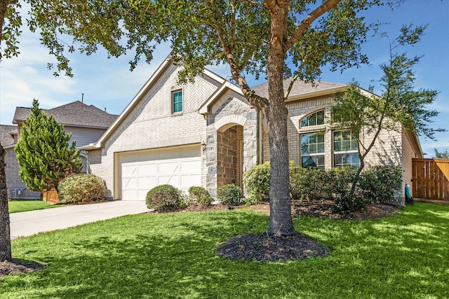 view of front of home featuring a garage and a front yard