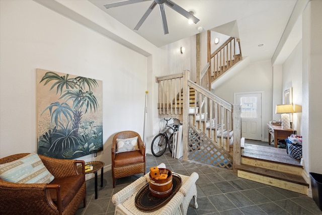 interior space with a high ceiling and ceiling fan