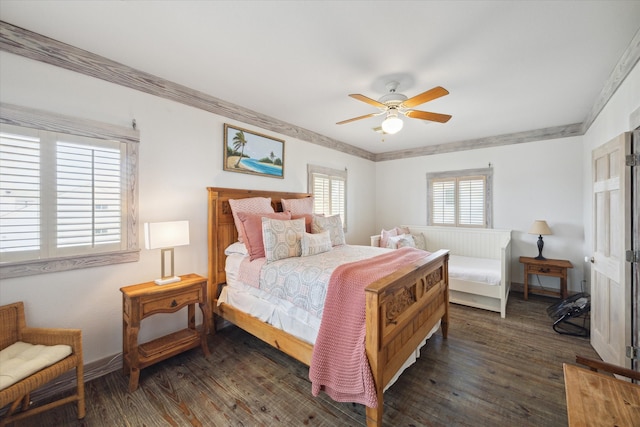 bedroom with dark hardwood / wood-style flooring, crown molding, and ceiling fan