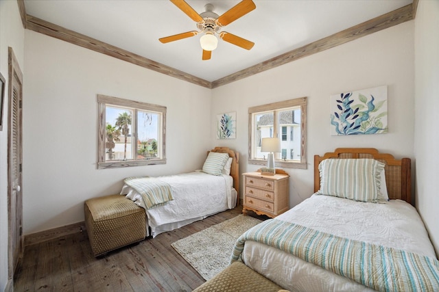 bedroom featuring wood-type flooring, ornamental molding, baseboards, and ceiling fan