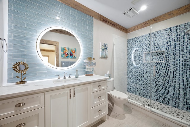 bathroom featuring toilet, vanity, tile walls, and a shower with door