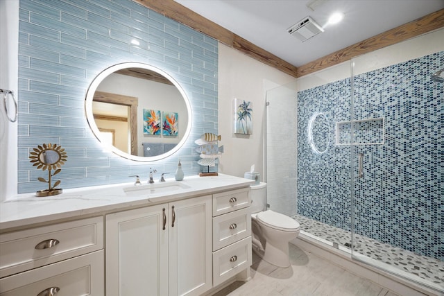 bathroom with a stall shower, tasteful backsplash, toilet, visible vents, and vanity