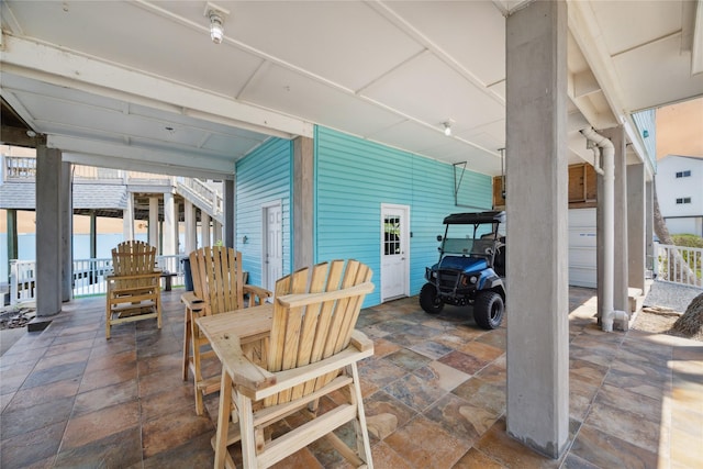 view of patio with outdoor dining area and stairway