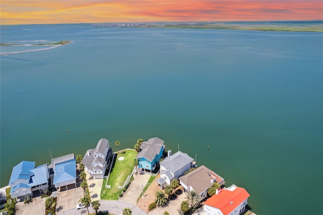 aerial view at dusk with a water view