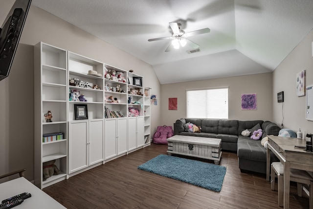 living room with dark wood-type flooring, vaulted ceiling, and ceiling fan