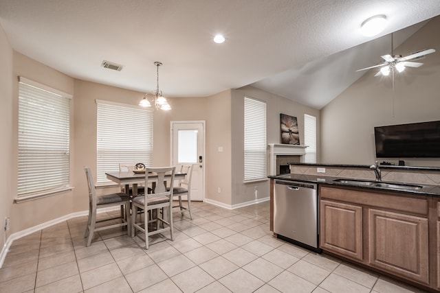 kitchen with ceiling fan with notable chandelier, light tile patterned floors, sink, and stainless steel dishwasher