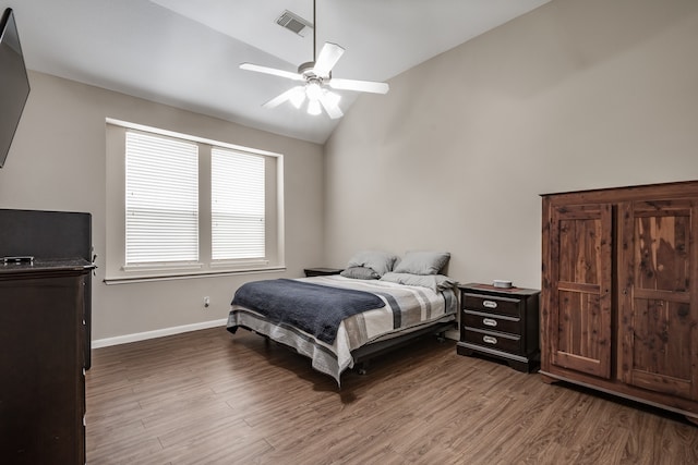 bedroom with light wood-type flooring, vaulted ceiling, and ceiling fan