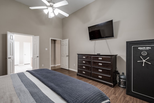 bedroom with high vaulted ceiling, ceiling fan, and wood-type flooring