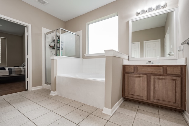 bathroom featuring vanity, independent shower and bath, and tile patterned floors