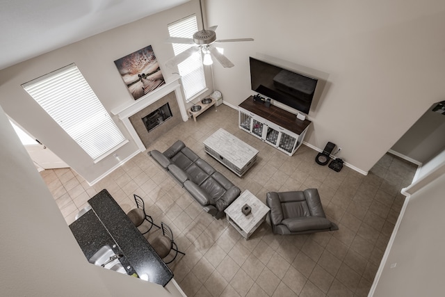 living room featuring ceiling fan and tile patterned floors