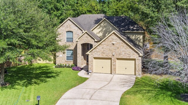 view of front of home featuring a garage and a front yard