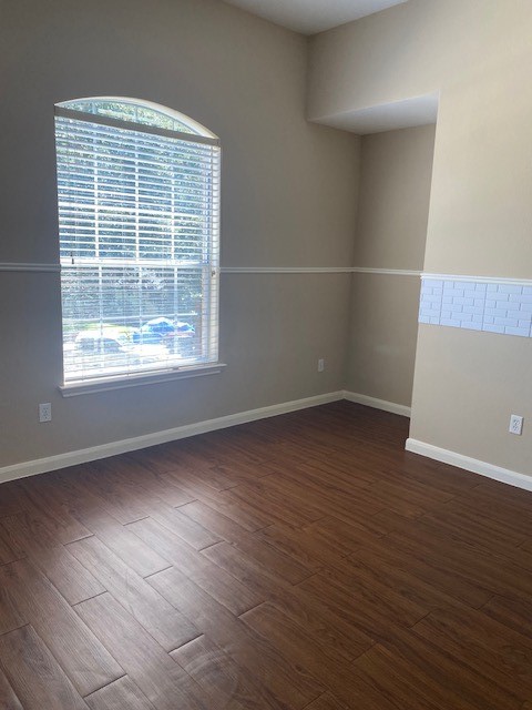 empty room with dark wood-type flooring