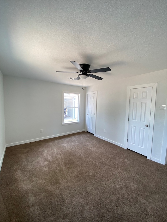 interior space featuring ceiling fan and a textured ceiling