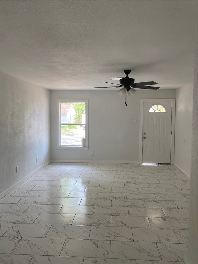 interior space featuring ceiling fan