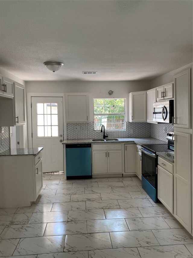 kitchen featuring sink, tasteful backsplash, light tile patterned flooring, and stainless steel appliances