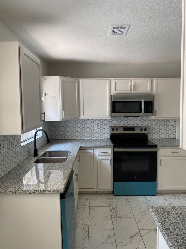 kitchen featuring sink, stainless steel appliances, and decorative backsplash