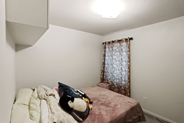 carpeted bedroom featuring a textured ceiling