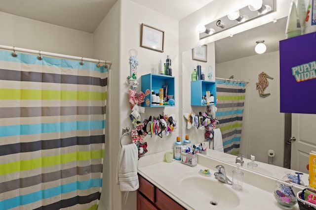 bathroom with walk in shower and vanity