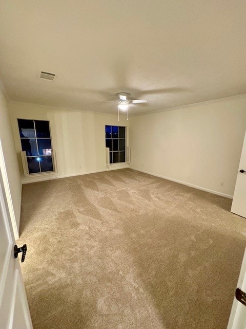 carpeted spare room with ceiling fan