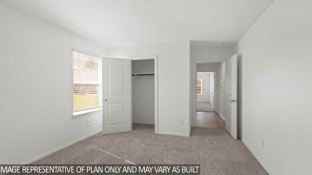 unfurnished bedroom with light carpet and a closet