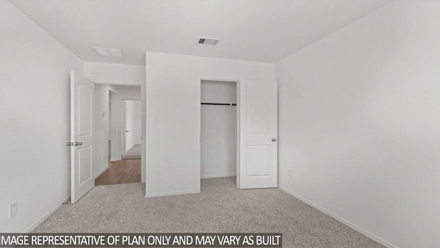 unfurnished bedroom with light carpet and a closet