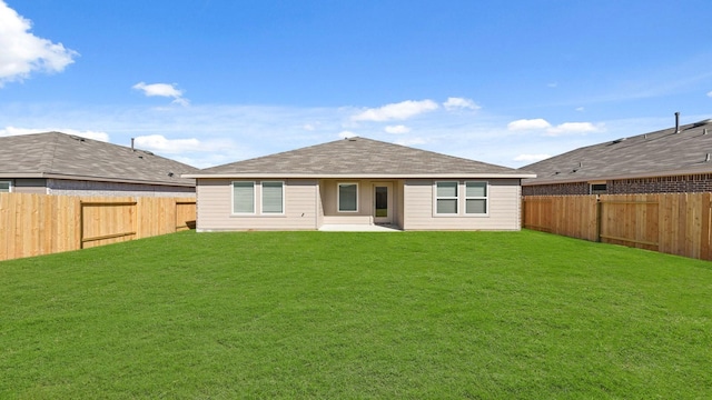 rear view of house with a lawn