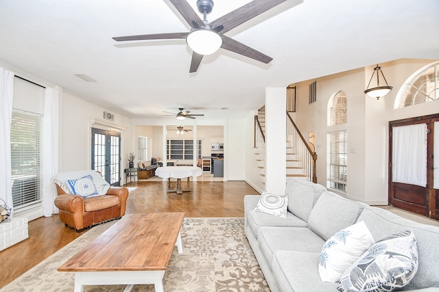 living room with ceiling fan, french doors, and wood-type flooring