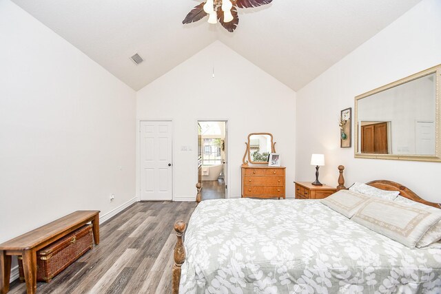 bedroom featuring ceiling fan, high vaulted ceiling, ensuite bath, and dark wood-type flooring