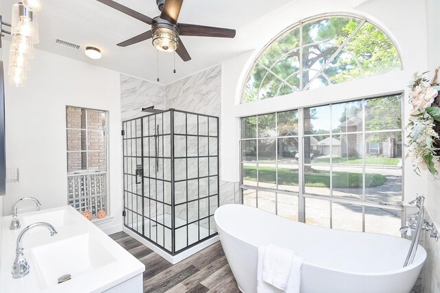 bathroom featuring sink, ceiling fan, separate shower and tub, and hardwood / wood-style flooring