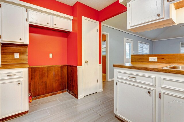 kitchen featuring light tile patterned flooring and white cabinets