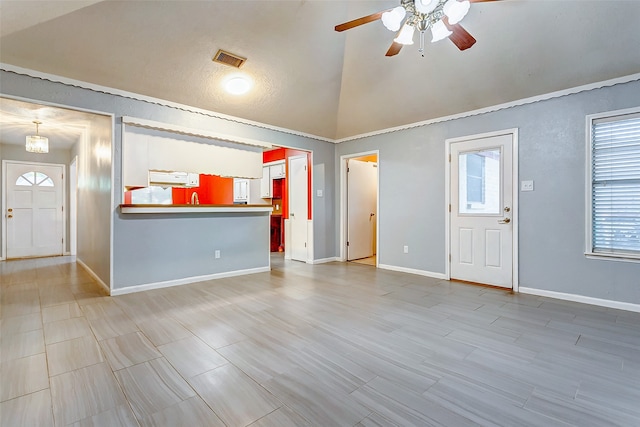 unfurnished living room with ceiling fan and vaulted ceiling