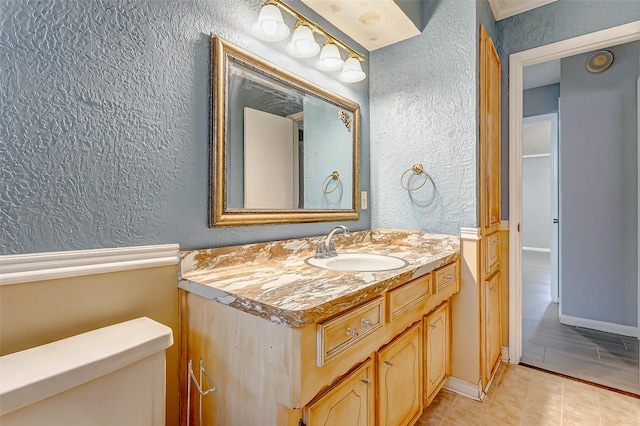 bathroom featuring tile patterned floors, toilet, and vanity