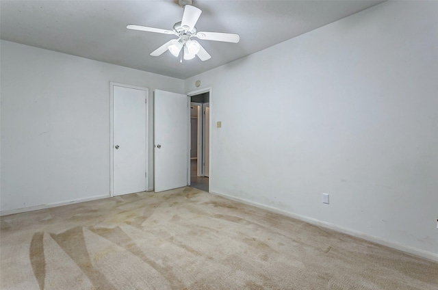 carpeted empty room featuring ceiling fan