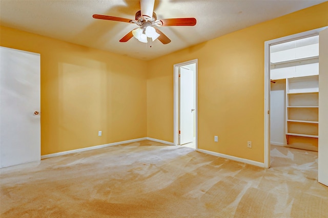 empty room with ceiling fan and light colored carpet