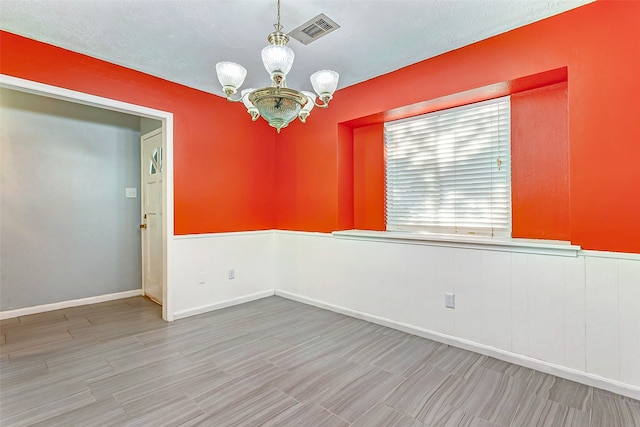 empty room featuring a chandelier