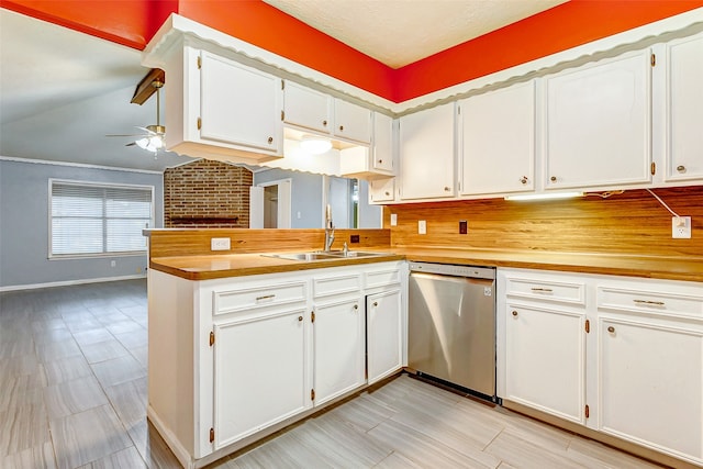 kitchen with backsplash, dishwasher, ceiling fan, kitchen peninsula, and brick wall