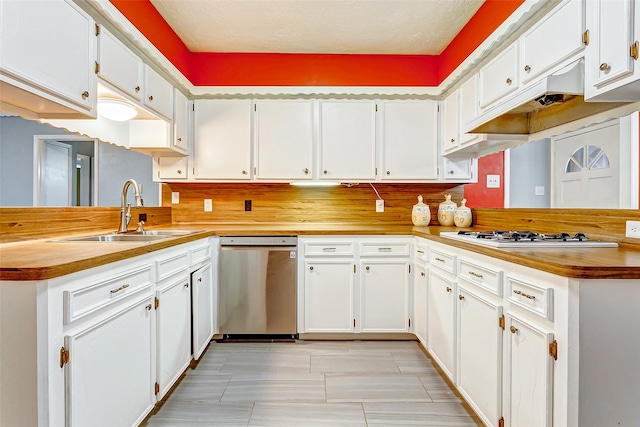 kitchen featuring sink, dishwasher, and white cabinetry