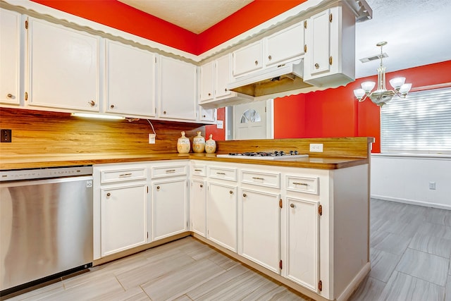 kitchen with a notable chandelier, white cabinetry, and stainless steel appliances