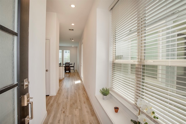 corridor with light hardwood / wood-style flooring