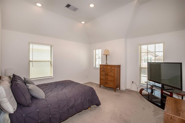 carpeted bedroom with vaulted ceiling and multiple windows