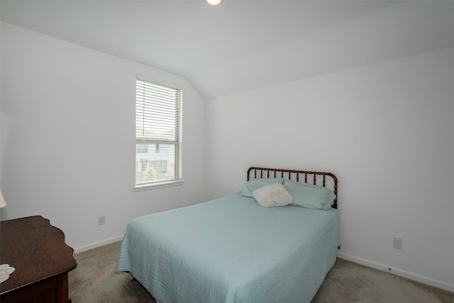 bedroom with lofted ceiling and carpet flooring